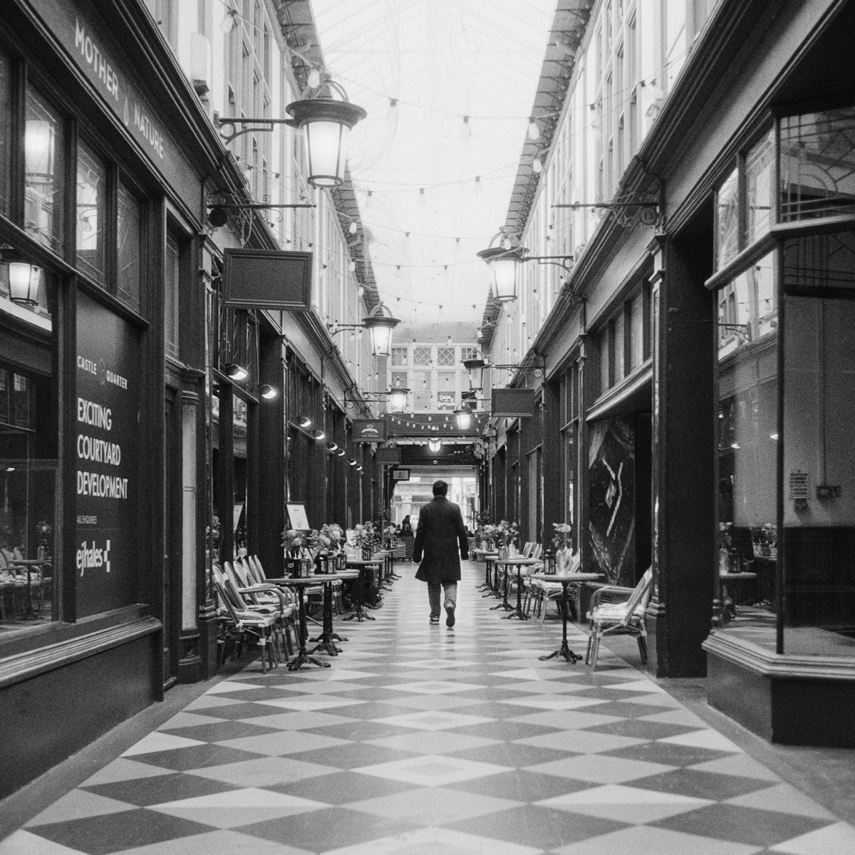 Figure walking through a Cardiff arcade